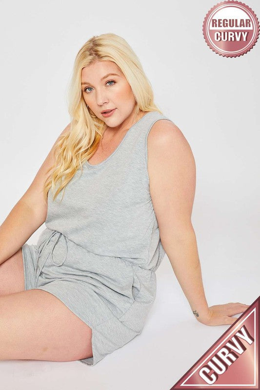 Woman wearing a gray sleeveless dress with 'Regular Curvy' and 'Curvy' labels on a white background.