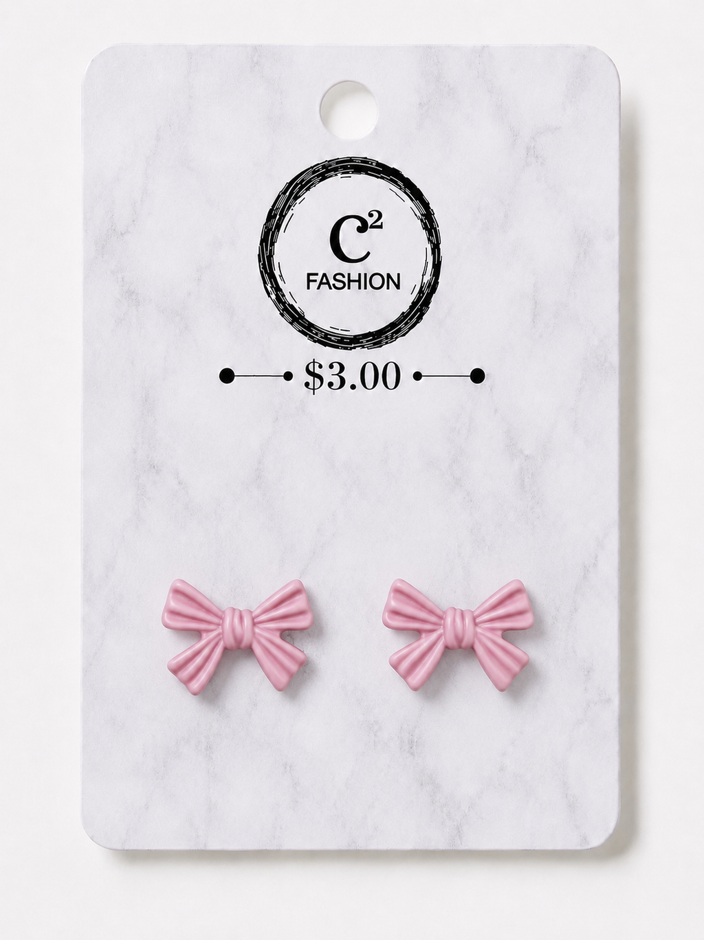 A pair of small pink bow stud earrings displayed on a white marble-style retail card with a circular logo reading C2 FASHION and a price of $3.00.