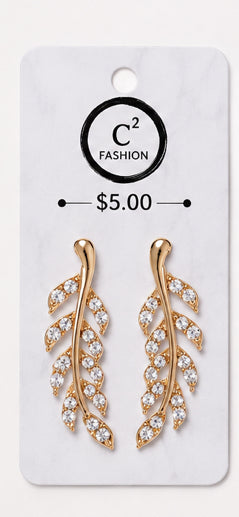 A pair of gold leaf-shaped drop earrings adorned with clear crystals, presented on a white display card with the brand name 'C2 FASHION' and a price of '$5.00'.