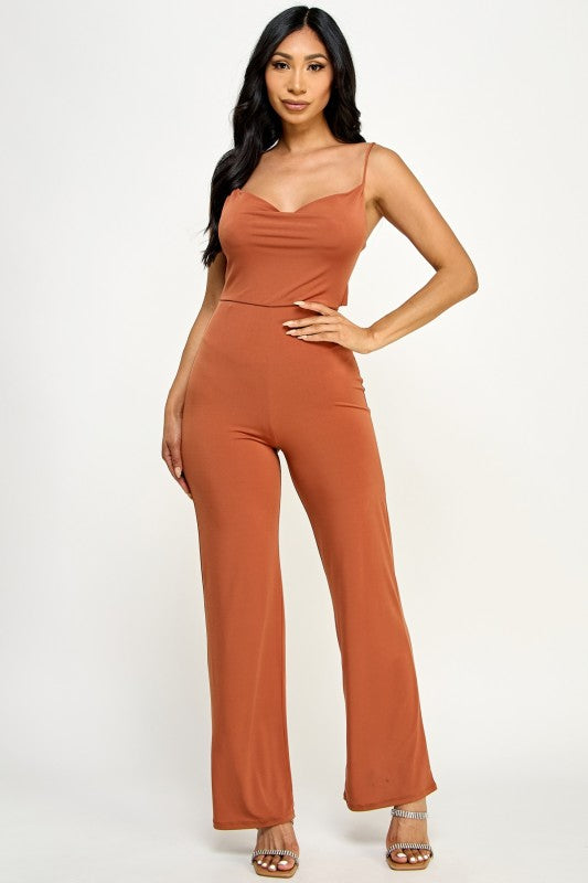 Woman wearing a brown jumpsuit on a white background