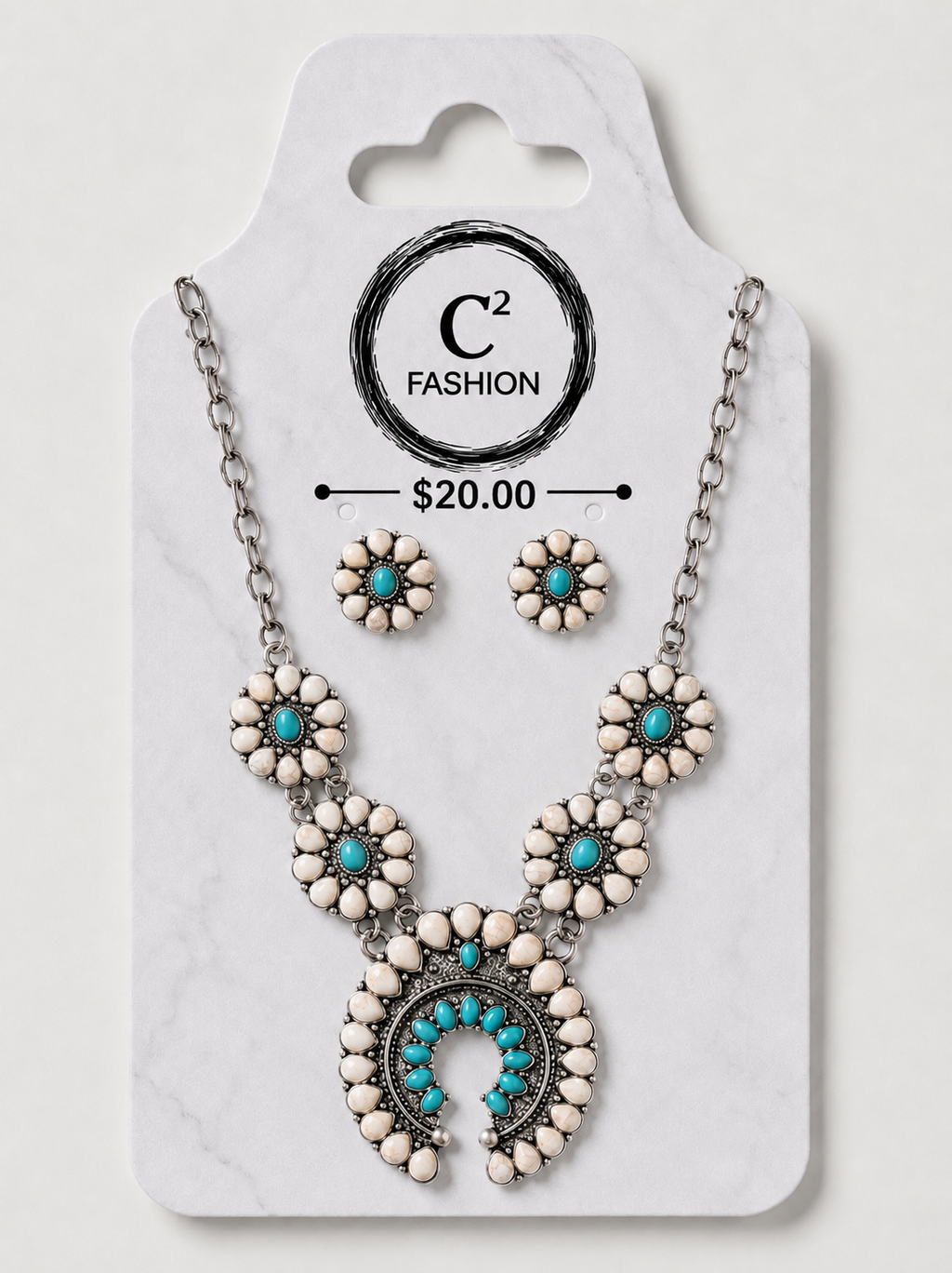A C2 Fashion jewelry set featuring a silver-tone necklace and matching stud earrings with white stone flower motifs and turquoise blue accents, displayed on a white marble-patterned retail card.