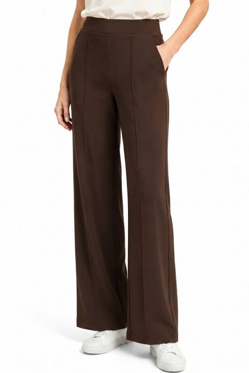 Brown wide-leg pants worn by a person on a white background