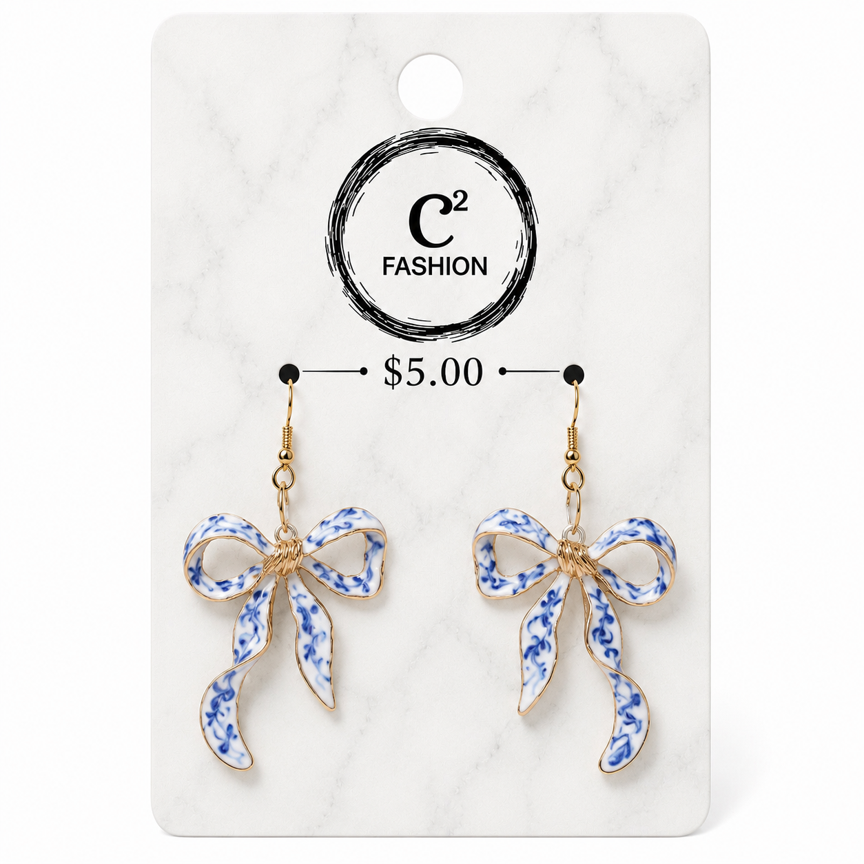 A pair of dangling bow earrings with blue and white floral enamel detailing and gold-tone hooks, displayed on a white marble-style retail card with the brand name C² FASHION and a price of $5.00.