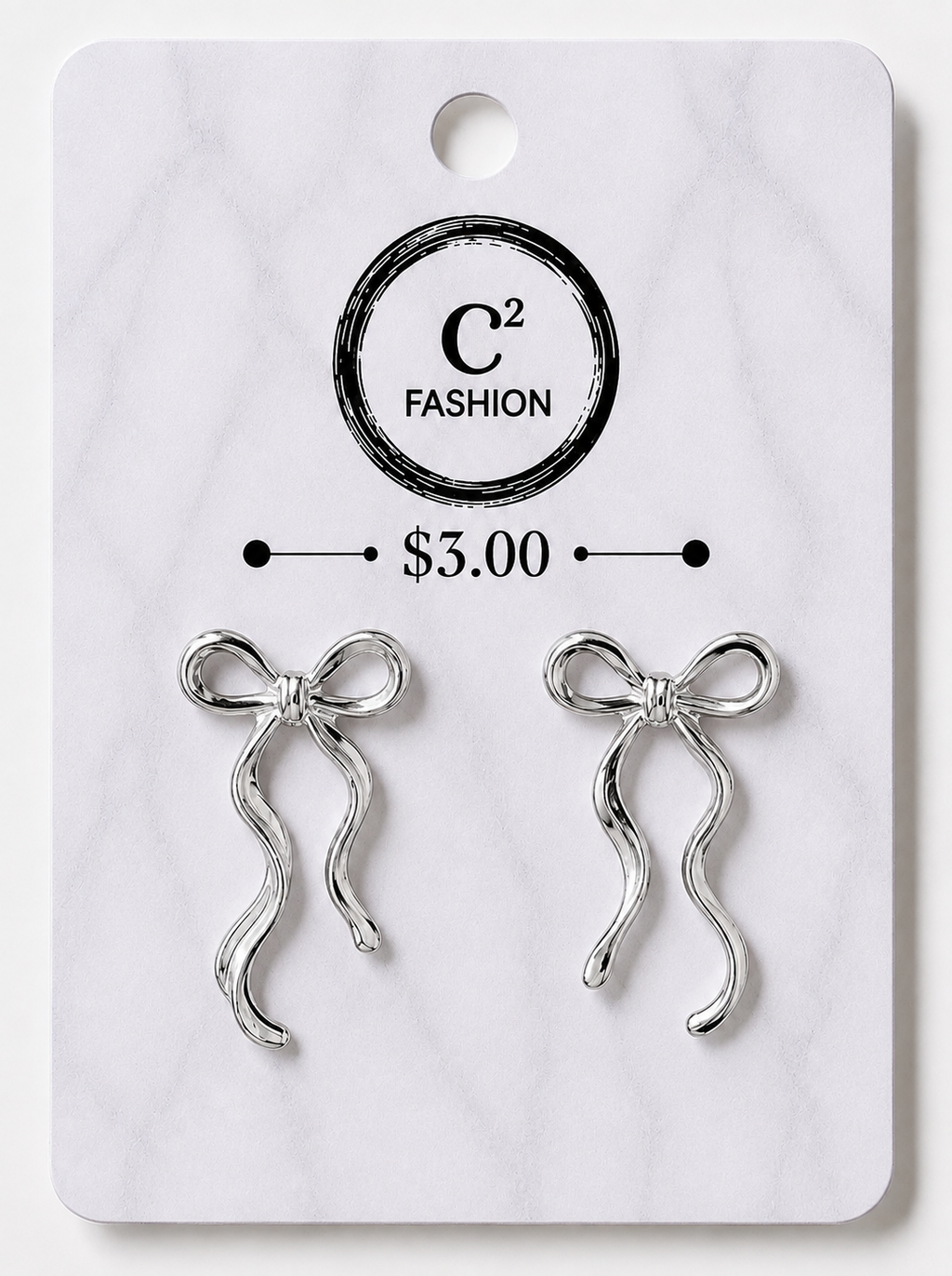 A pair of silver bow-shaped earrings displayed on a white marble-style retail card with the brand name C2 FASHION and a price of $3.00 printed on it.