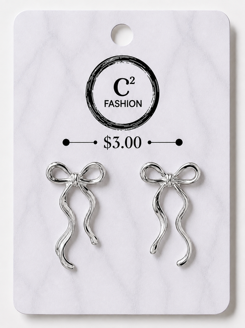 A pair of silver bow-shaped earrings displayed on a white marble-style retail card with the brand name C2 FASHION and a price of $3.00 printed on it.