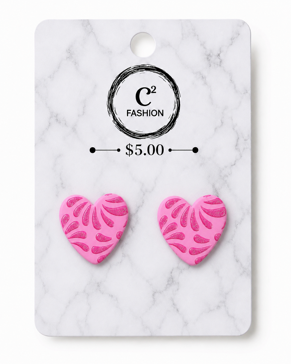 A pair of bright pink heart-shaped stud earrings with a textured, raised leaf-like pattern, mounted on a white marble-patterned display card featuring the brand 'C2 FASHION' and a price of '$5.00'.