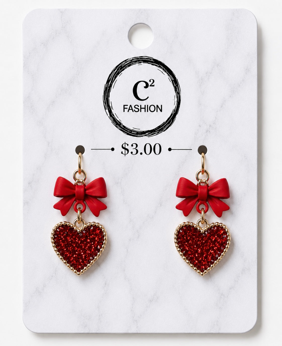 A pair of red heart-shaped dangling earrings with red bow charms, displayed on a white marble-patterned retail card. The card shows the brand name 'C2 FASHION' and a price of '$3.