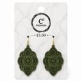 A pair of olive green laser-cut dangle earrings with gold hooks, displayed on a white marble-patterned card with the brand logo 'C2 FASHION' and a price of '$5.00' printed on it.