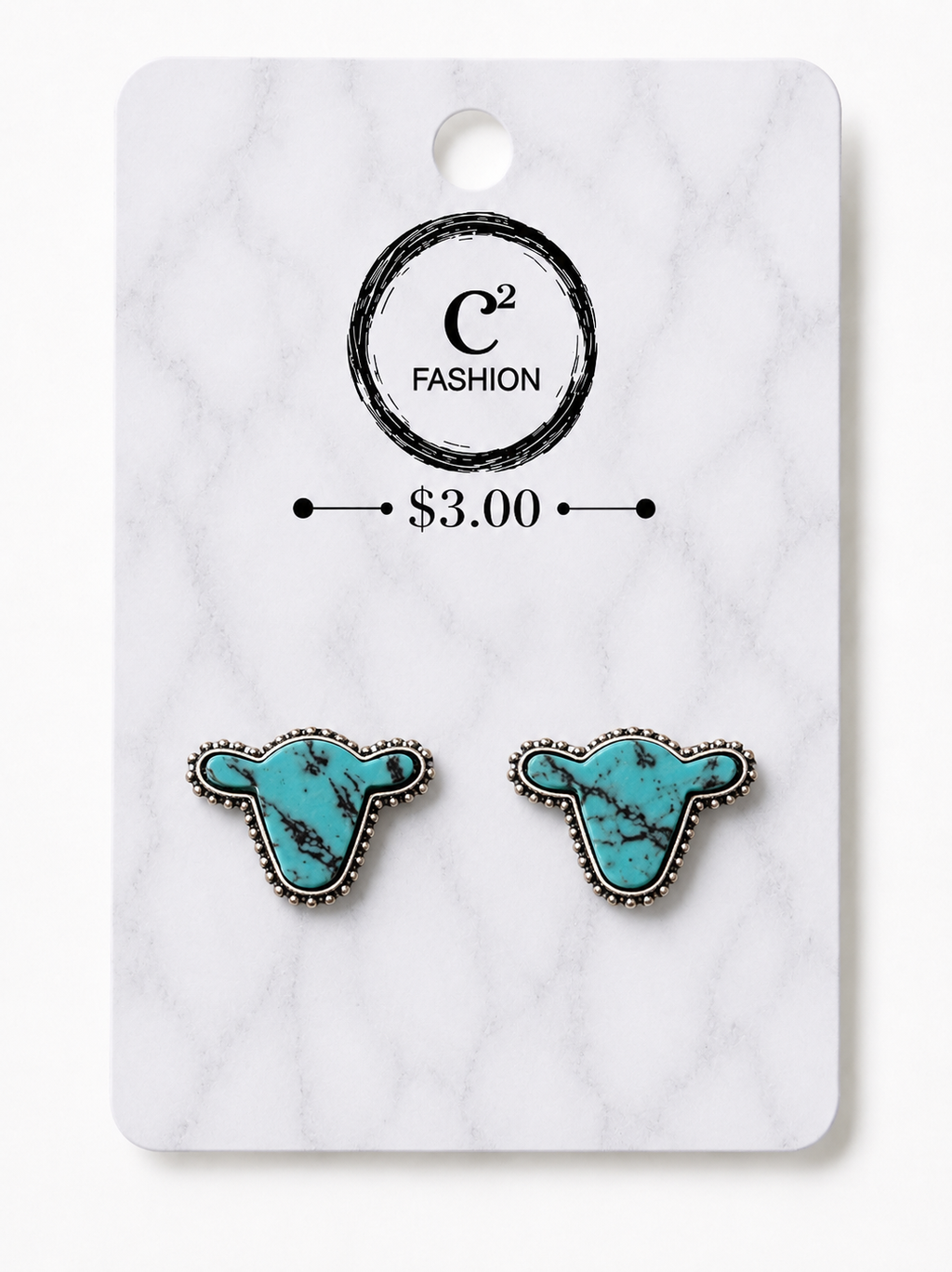 A pair of cow-shaped turquoise stud earrings with silver-toned beaded borders, displayed on a white marble-patterned card with the brand name C2 FASHION and a $3.00 price printed on it.
