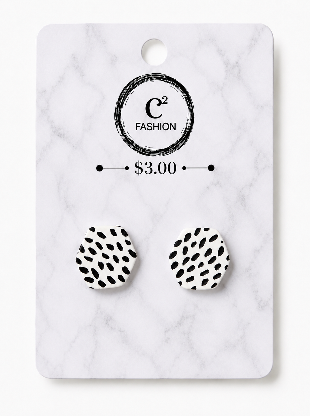 A pair of black-and-white spotted stud earrings mounted on a white marble-style display card with the C² FASHION logo and a $3.00 price printed on it.