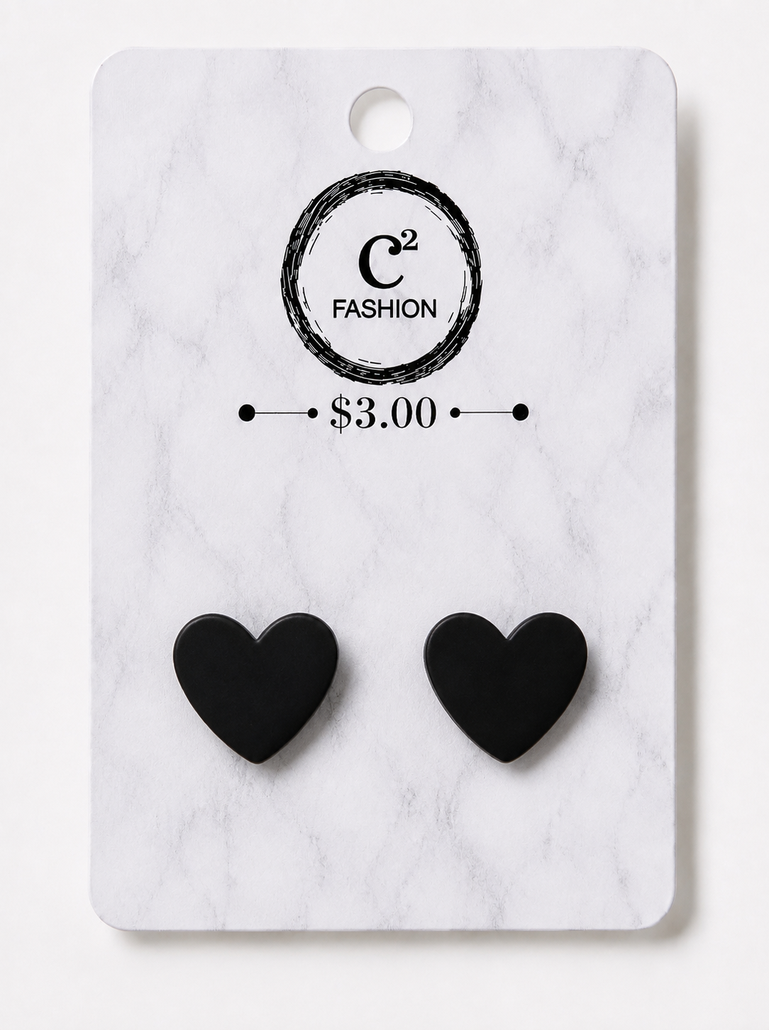 A pair of small black heart-shaped stud earrings displayed on a white marble-style retail card with the C2 FASHION logo and $3.00 price printed above them.