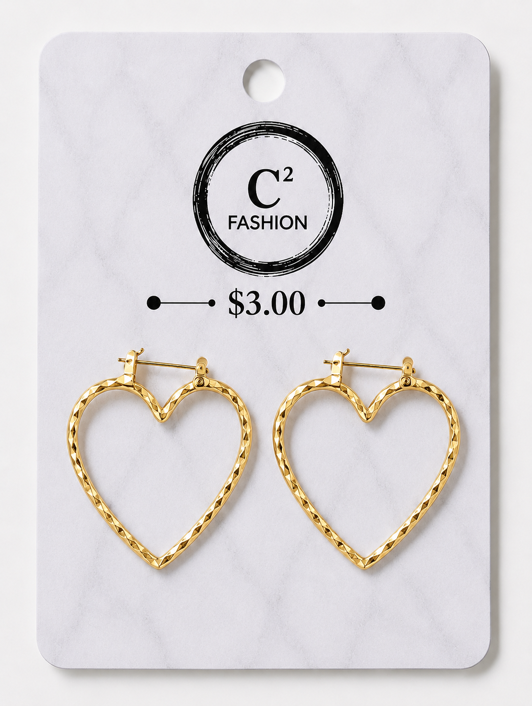 A pair of gold heart-shaped hoop earrings with a twisted rope texture, displayed on a white marble-patterned retail card featuring the brand name 'C² FASHION' and a price of '$3.00'.