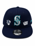 Navy Mariners snapback with front compass 'S' logo, American League patch, and 1977 anniversary embroidery.