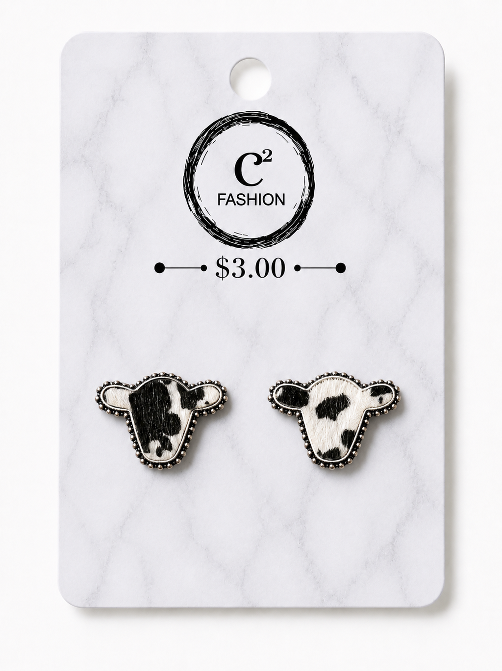 A pair of cow head stud earrings displayed on a white marble-style backing card. The card shows the brand name 'C2 FASHION' and a price of '$3.