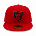 Red cap with a black logo featuring a face and 'RAIDERS' text on a white background