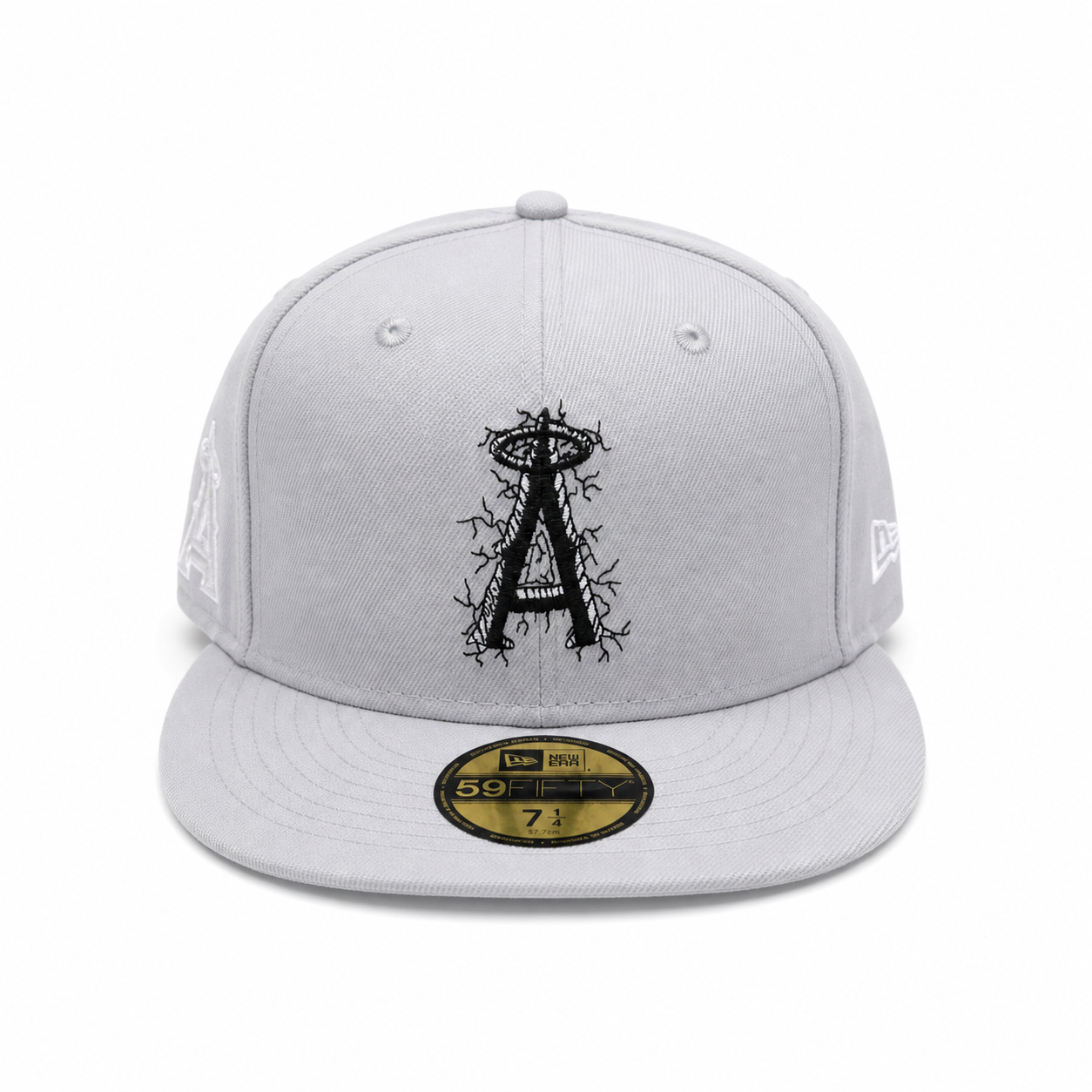 Grey fitted cap with black cracked “A” logo, flat brim, and 59FIFTY sticker on a clean white background