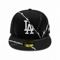 Black fitted cap with white LA logo and barbed wire embroidery design, flat brim, and 59FIFTY sticker on a clean white background