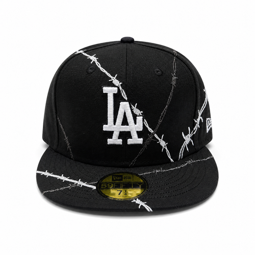 Black fitted cap with white LA logo and barbed wire embroidery design, flat brim, and 59FIFTY sticker on a clean white background