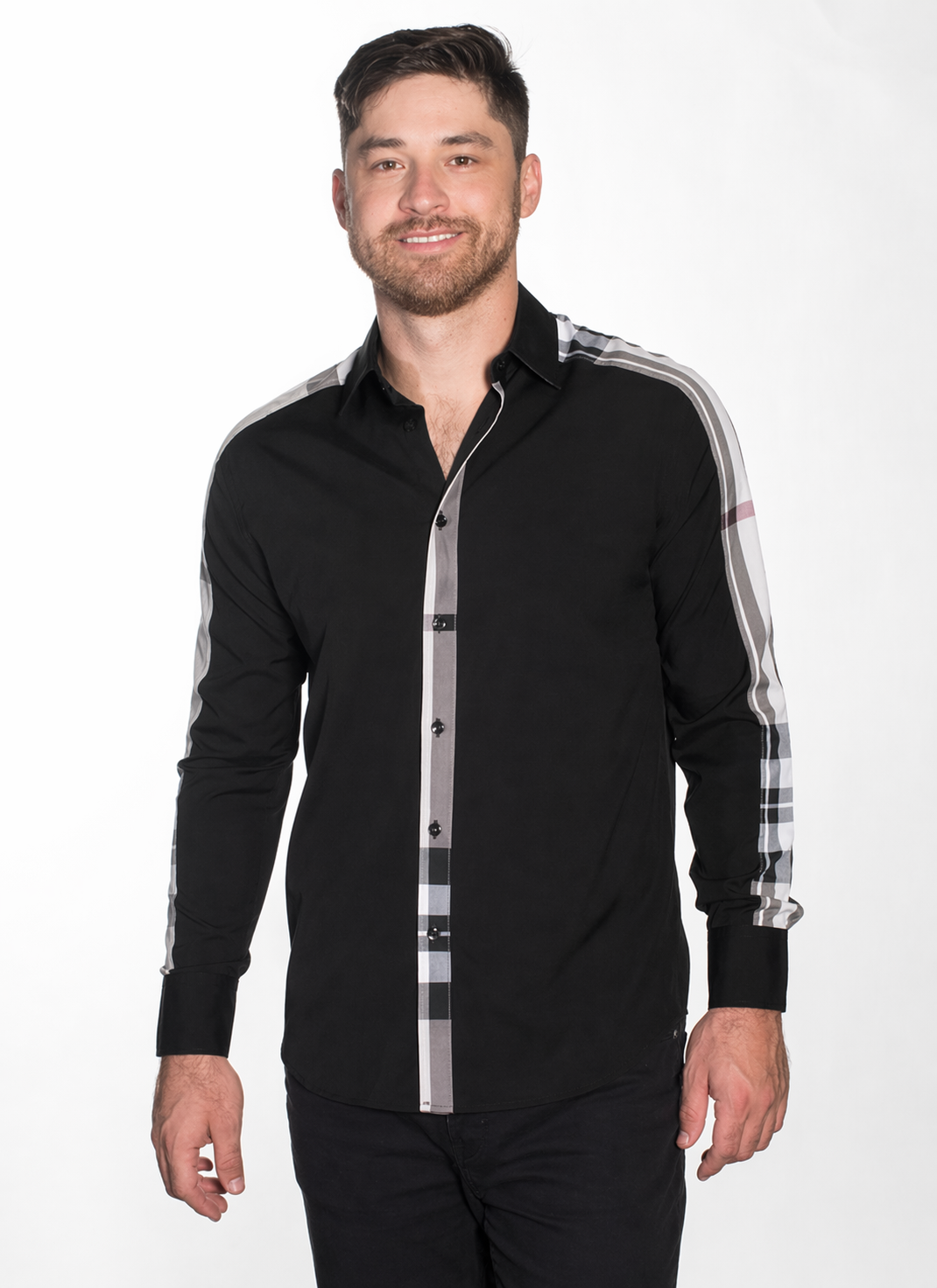 Man wearing a black shirt with plaid sleeves on a white background
