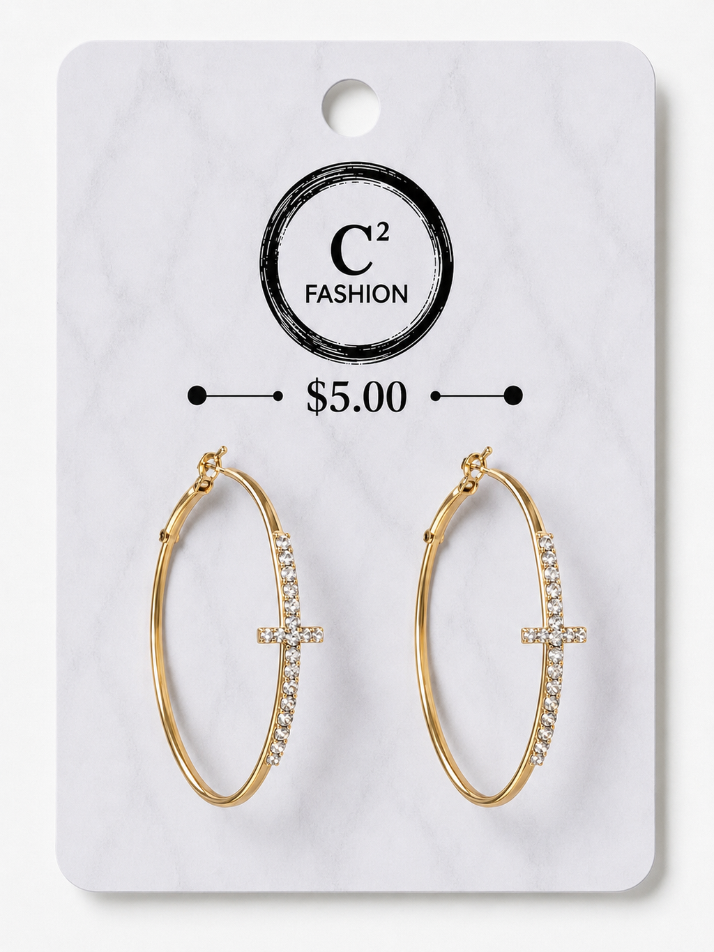 A pair of gold hoop earrings with a small cross charm set with clear crystals, displayed on a white marble-patterned retail card labeled C² FASHION and $5.00.