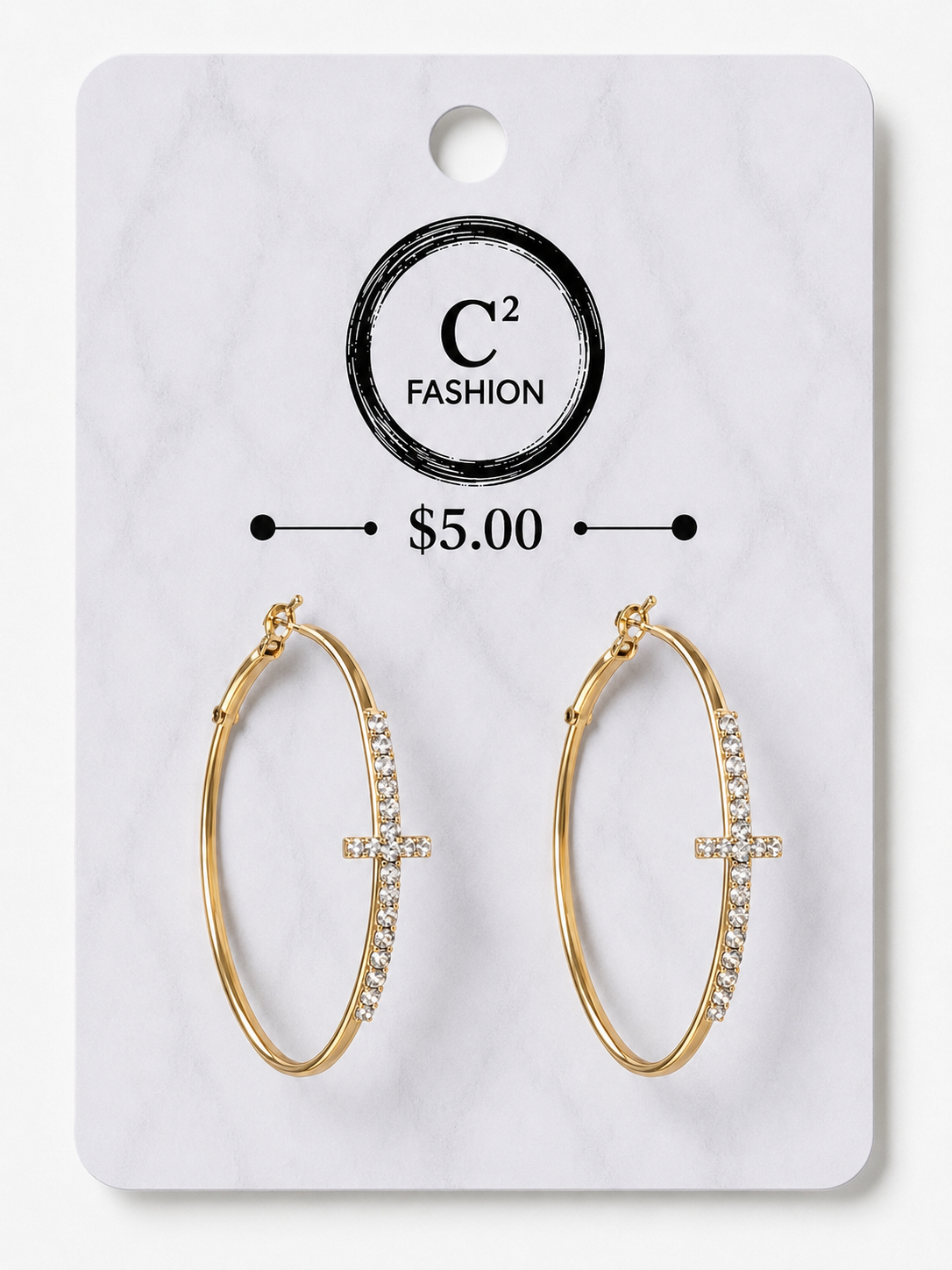 A pair of gold hoop earrings with a small cross charm set with clear crystals, displayed on a white marble-patterned retail card labeled C² FASHION and $5.00.