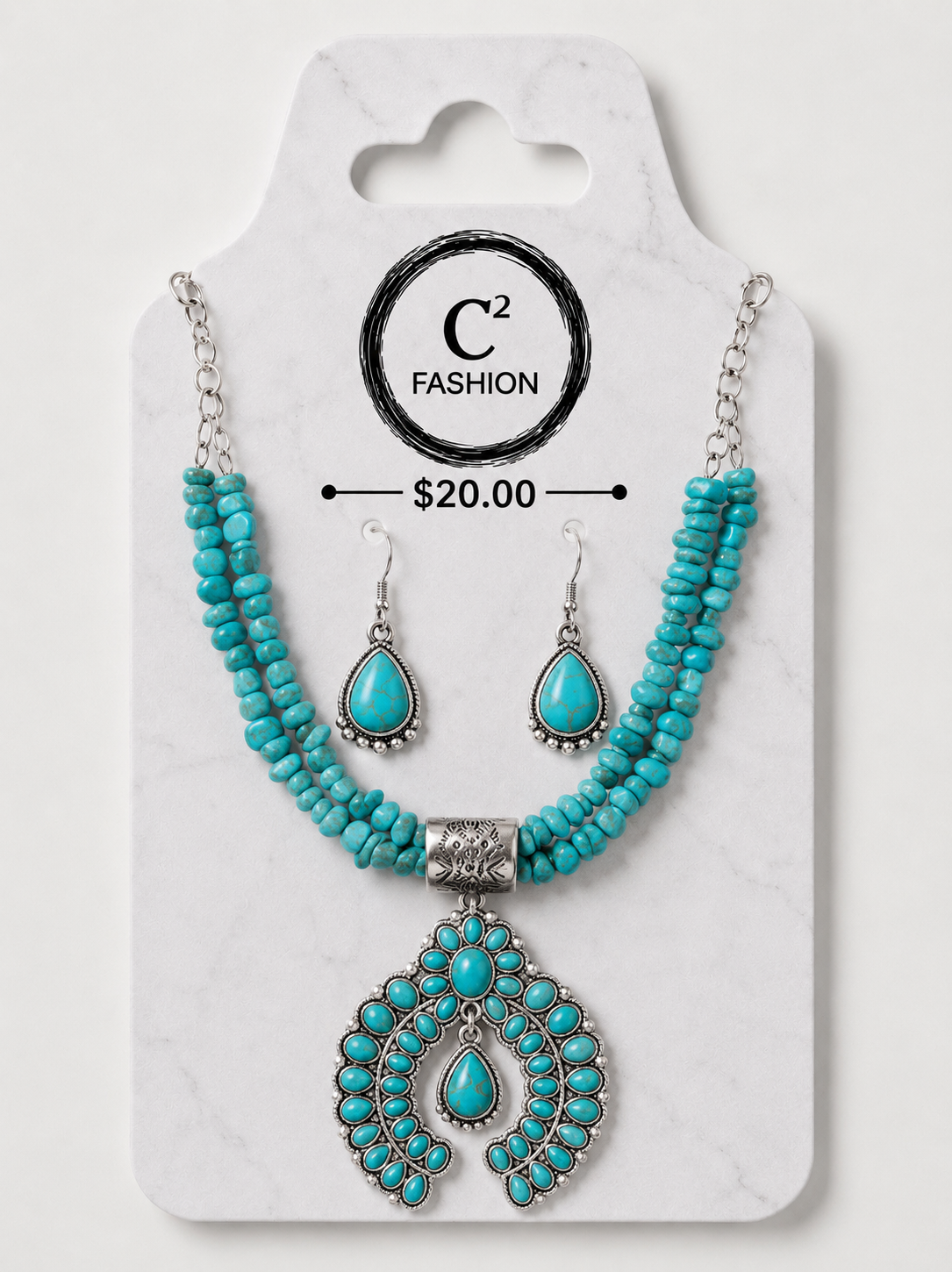A turquoise and silver jewelry set displayed on a white marble-style card. The set includes a beaded necklace with a large ornate pendant, matching drop earrings, and printed branding for C2 FASHION with a price of $20.