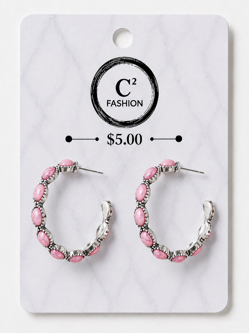 A pair of silver-tone hoop earrings with pink oval rhinestones, displayed on a white marble-patterned retail card with the brand name C² FASHION and a $5.00 price printed on it.