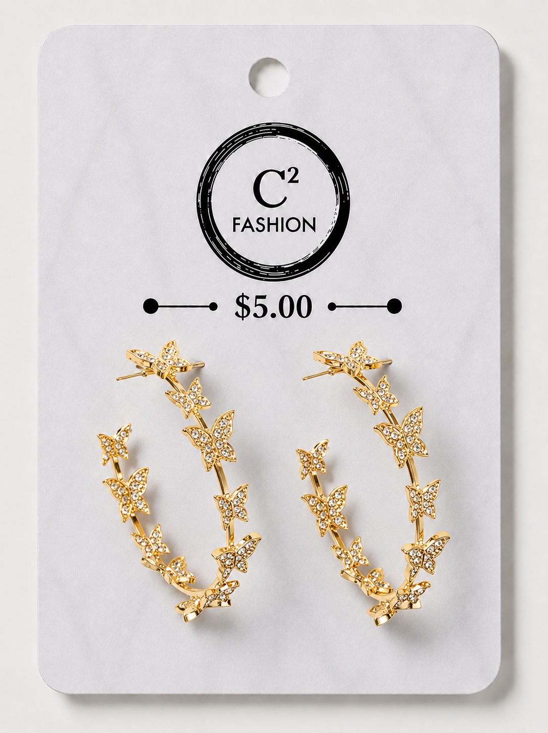 A pair of gold crescent-shaped hoop earrings decorated with small star and leaf motifs, displayed on a white C² FASHION brand card labeled $5.00.