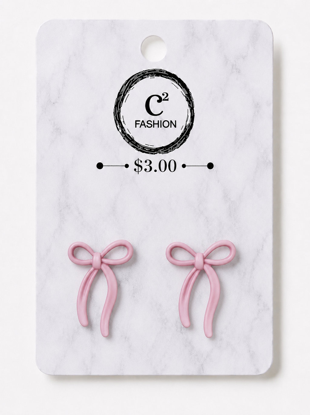 A pair of small pink bow-shaped earrings displayed on a white marble-style retail card with a circular C² FASHION logo and a $3.00 price mark.