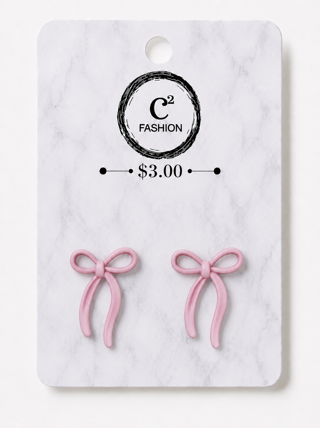 A pair of small pink bow-shaped earrings displayed on a white marble-style retail card with a circular C² FASHION logo and a $3.00 price mark.