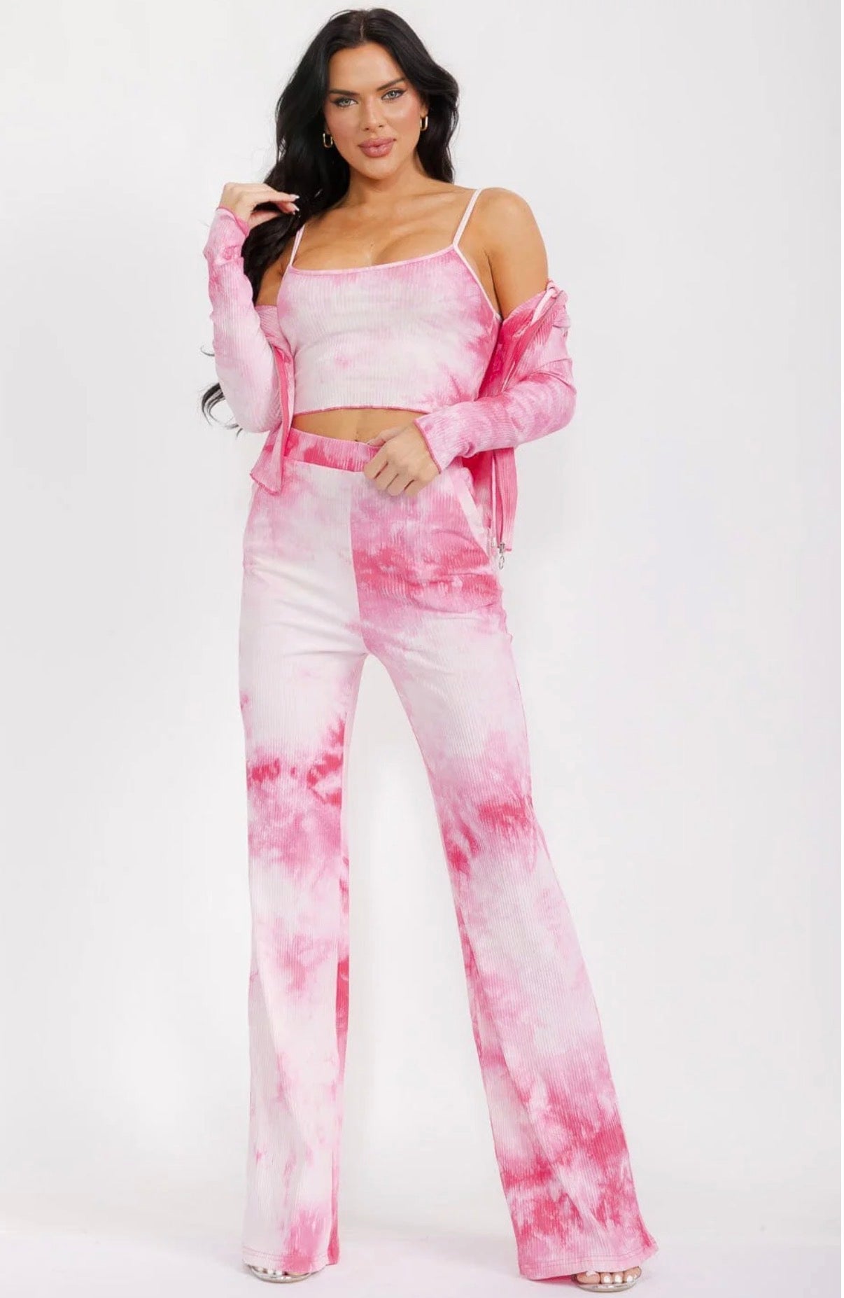 Woman wearing a pink tie-dye outfit on a white background