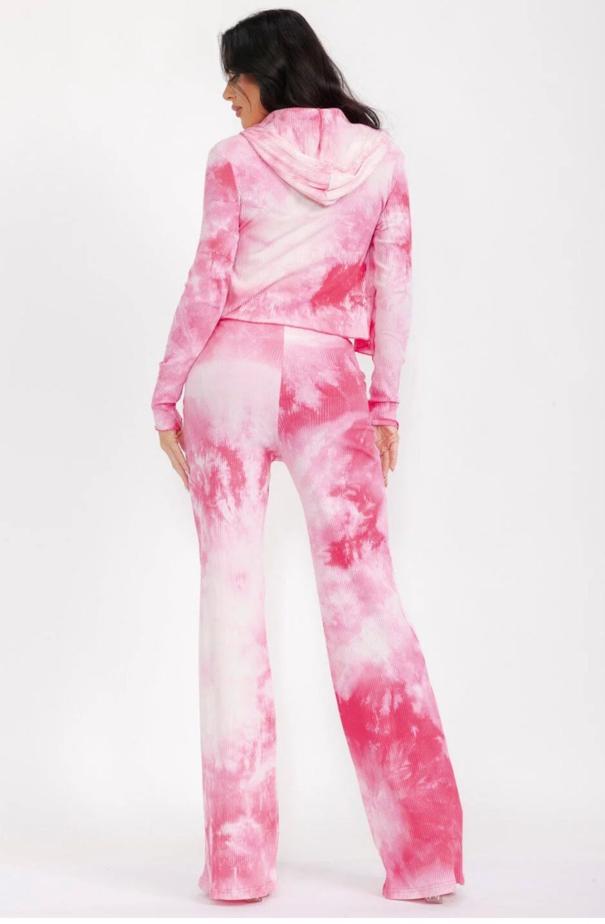 Woman wearing a pink tie-dye outfit on a white background