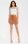 Woman wearing a white top and brown skirt on a white background