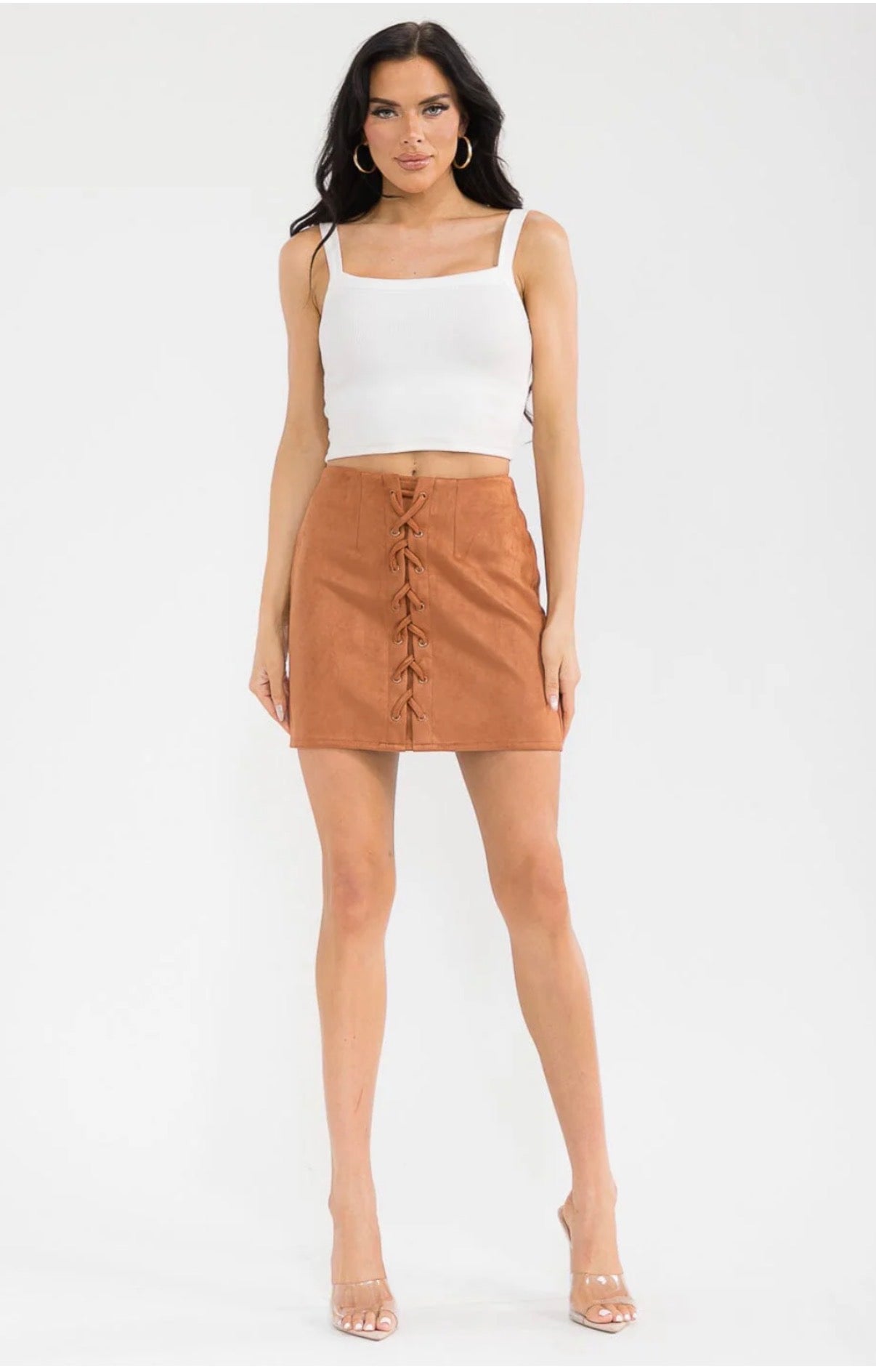 Woman wearing a white top and brown skirt on a white background