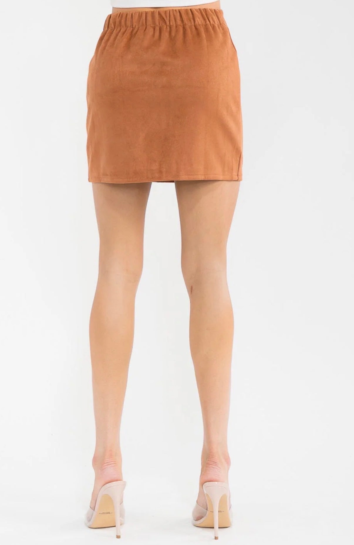 Tan mini skirt worn by a person on a white background