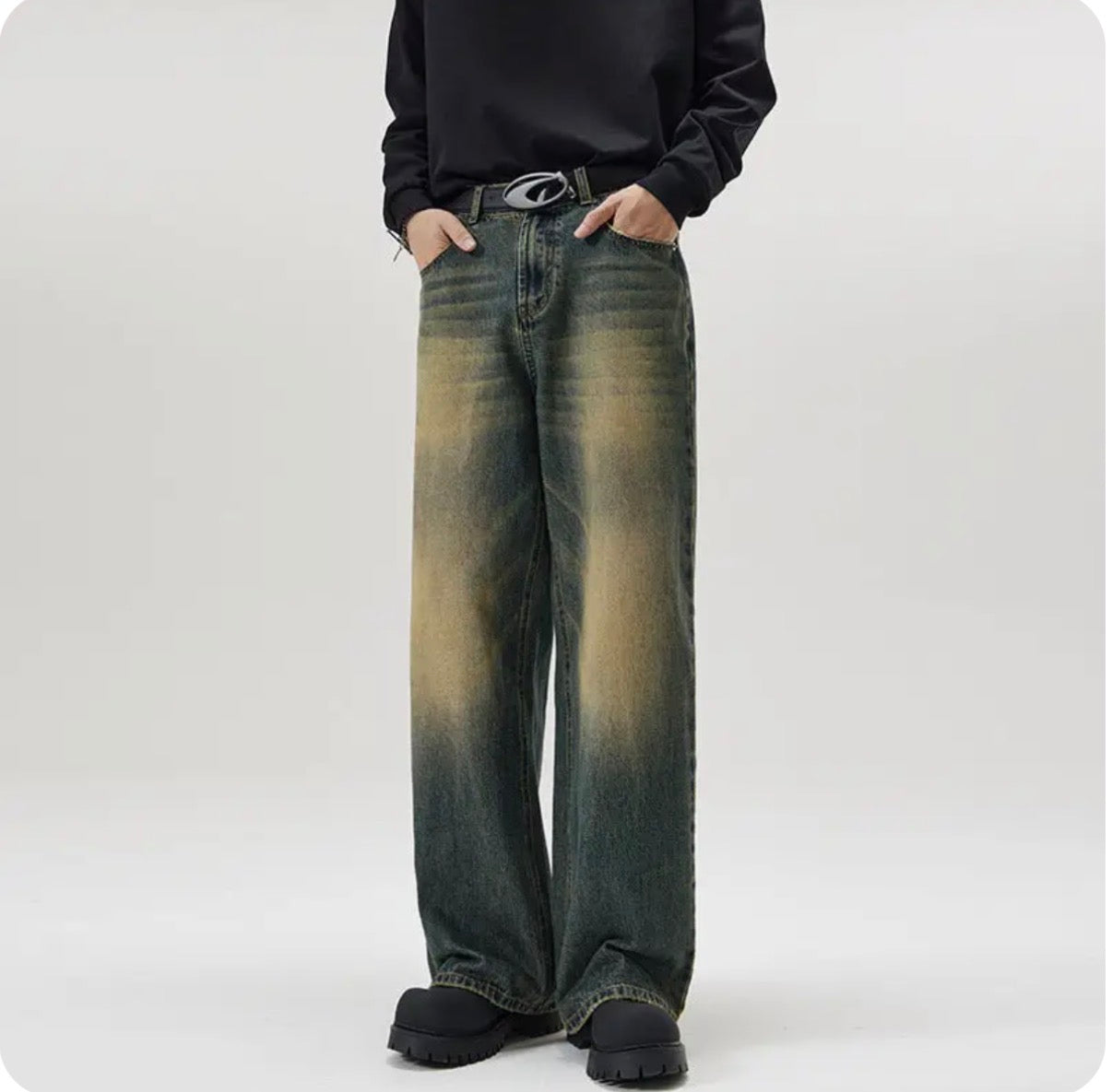 Person wearing a pair of wide-leg jeans with a gradient effect on a white background