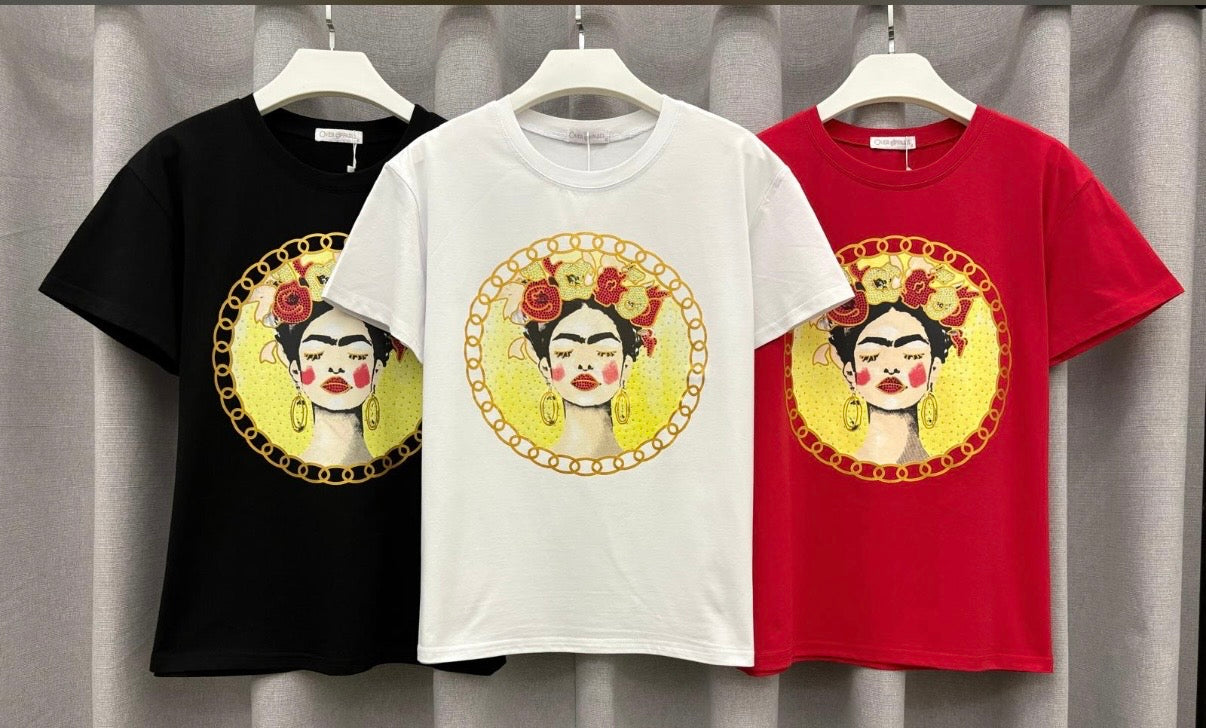 Three t-shirts in black, white, and red with a graphic design of a face on hangers against a gray curtain background.
