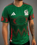 man wearing soccer jersey color green and red. 