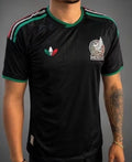 man wearing black soccer jersey. 