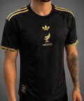 man wearing gold and black mexico jersey