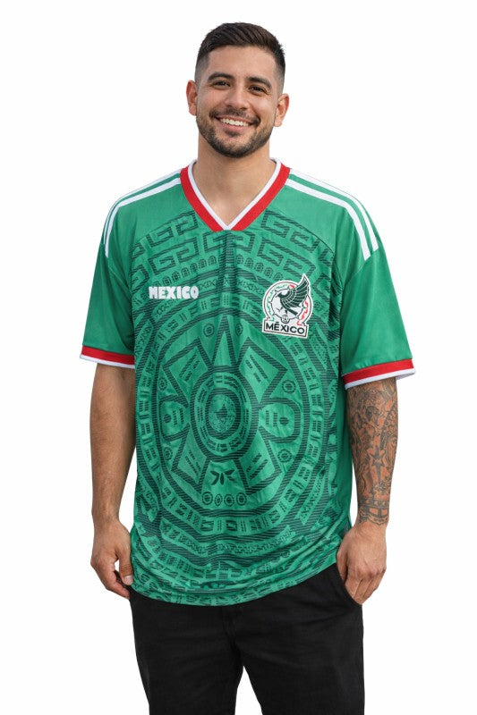 Man wearing a green Mexico soccer jersey with a white background