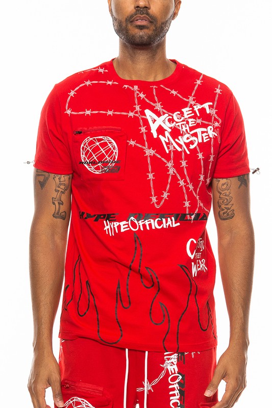 Person wearing a red graphic t-shirt with various designs and text.