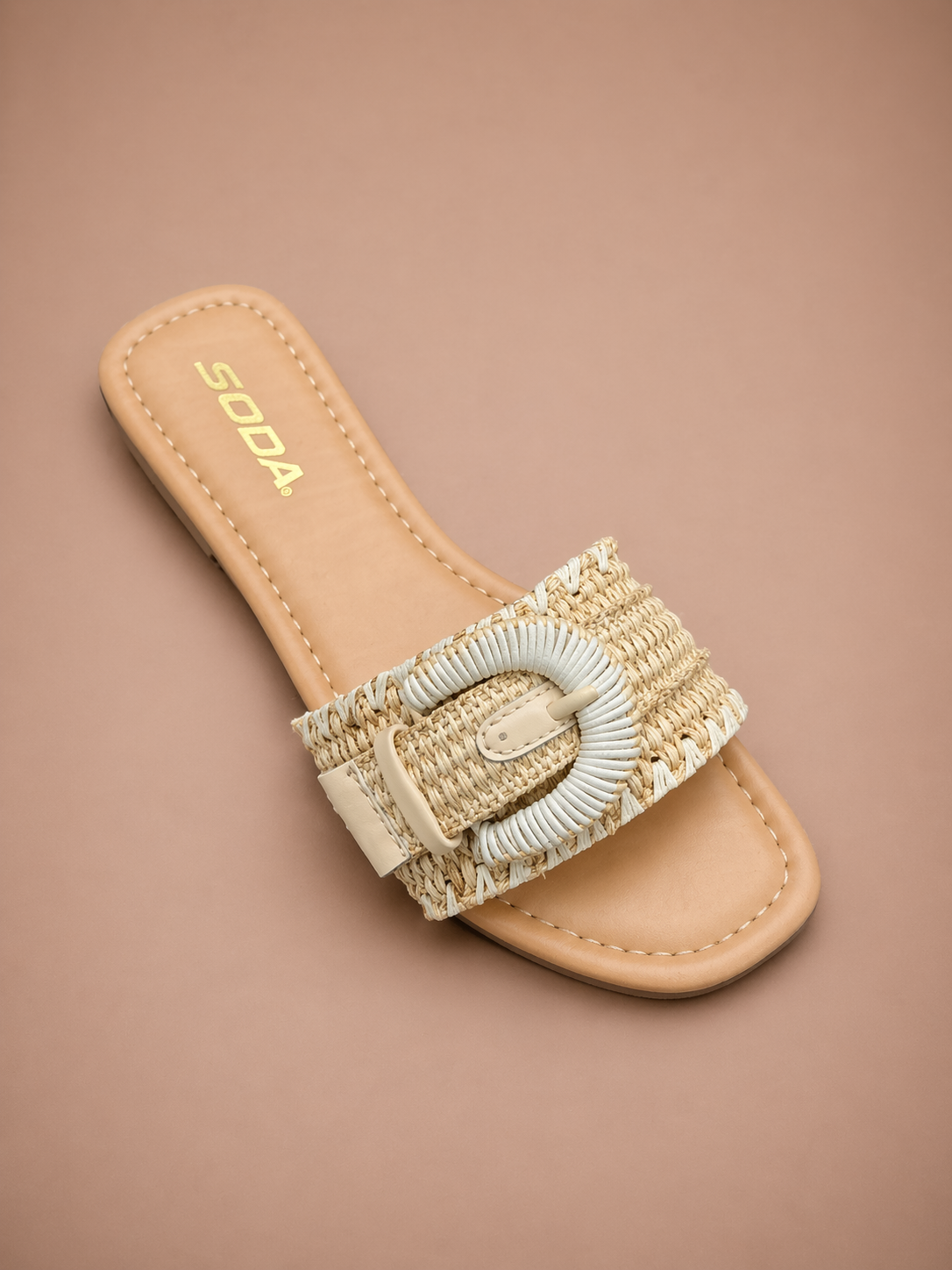 Beige sandal with woven strap and buckle on a beige background