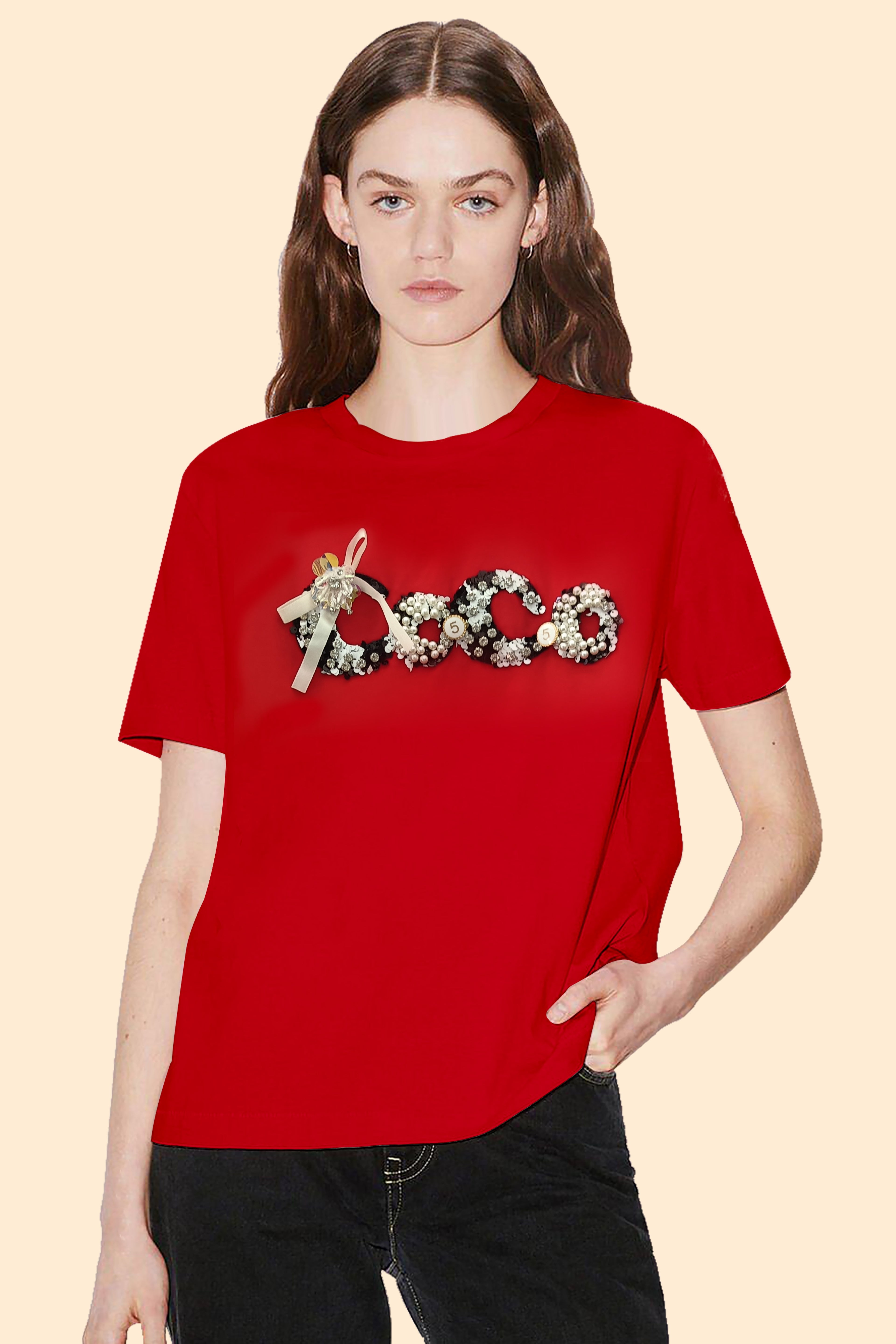 Person wearing a red t-shirt with decorative text on a beige background