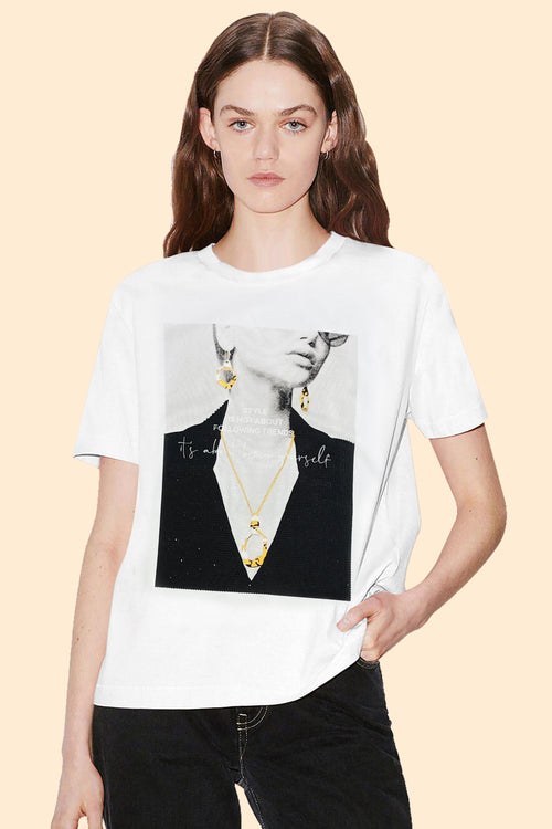 Model wearing a white t-shirt with a graphic design on a beige background