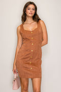 Woman wearing a brown button-up dress against a plain background