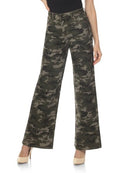 A model wearing a pair of wide-leg camouflage pants with a green, brown, and black camo pattern, paired with a black top and beige high heels, shown from the waist down on a white background.