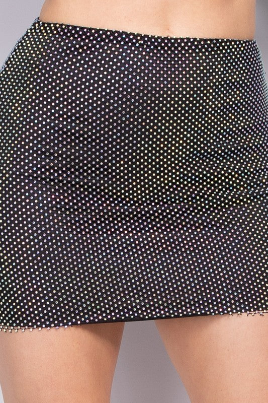Black polka dot skirt worn by a person on a neutral background
